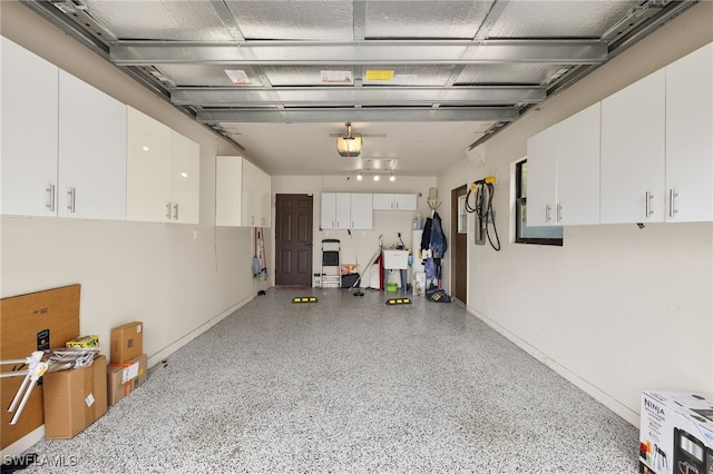 3270 14th Ave NE, Naples, FL 34120 - garage with a garage door opener and baseboards