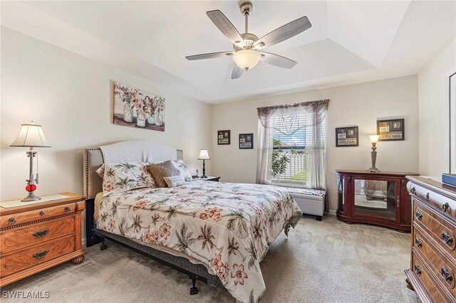 2619 42nd St SW, Lehigh Acres, FL 33976 - bedroom with light carpet, a tray ceiling, and a ceiling fan