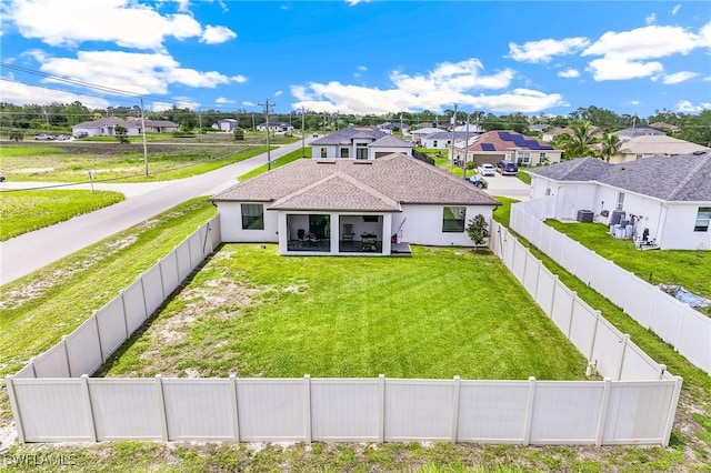 2619 42nd St SW, Lehigh Acres, FL 33976 - back of house with a residential view, a fenced backyard, and a shingled roof