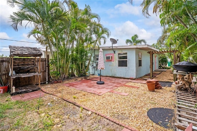 751 108th Ave N, Naples, FL 34108 - rear view of house featuring a patio, stucco siding, a gate, and a pergola