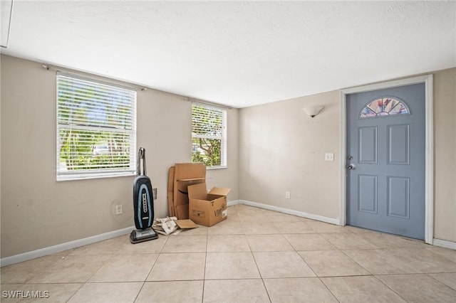 751 108th Ave N, Naples, FL 34108 - foyer entrance with light tile patterned flooring and baseboards