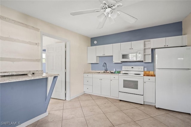 751 108th Ave N, Naples, FL 34108 - kitchen with white appliances, white cabinets, light countertops, and light tile patterned flooring