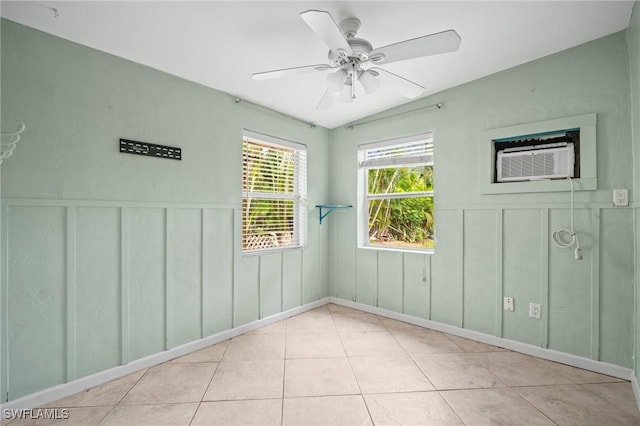751 108th Ave N, Naples, FL 34108 - unfurnished room featuring a decorative wall, tile patterned flooring, a ceiling fan, wainscoting, and a wall mounted air conditioner