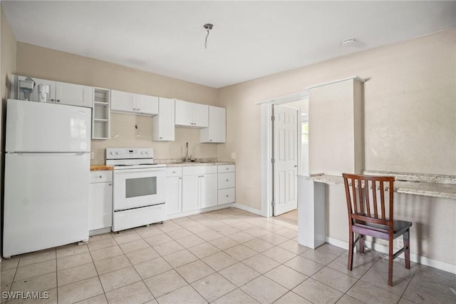 751 108th Ave N, Naples, FL 34108 - kitchen featuring white appliances, white cabinets, light tile patterned floors, light stone countertops, and open shelves