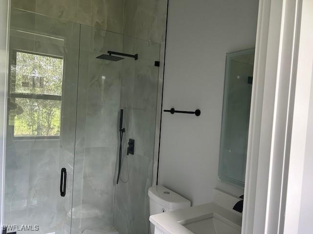3501 E 10th St, Lehigh Acres, FL 33972 - full bathroom featuring a shower stall, healthy amount of natural light, and vanity