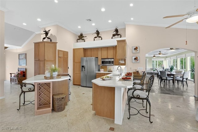 6120 Henderson Rd, Sanibel, FL 33957 - kitchen featuring stainless steel appliances, ceiling fan, crown molding, a peninsula, and high vaulted ceiling