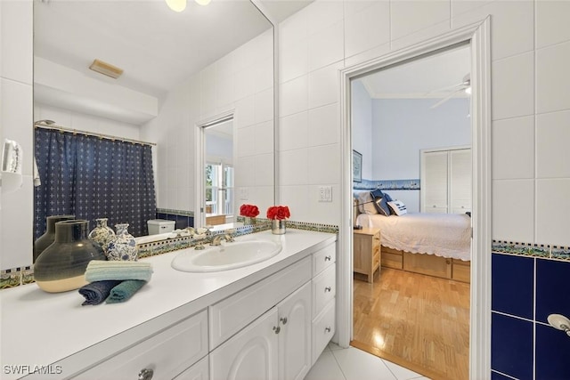6120 Henderson Rd, Sanibel, FL 33957 - full bathroom with connected bathroom, vanity, tile walls, and tile patterned flooring