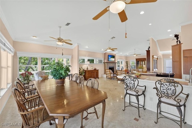 6120 Henderson Rd, Sanibel, FL 33957 - dining room with ceiling fan, plenty of natural light, crown molding, a fireplace, and recessed lighting