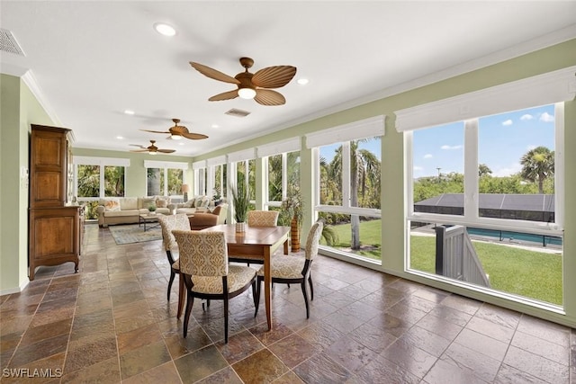 6120 Henderson Rd, Sanibel, FL 33957 - sunroom / solarium featuring ornamental molding, stone tile flooring, recessed lighting, and plenty of natural light