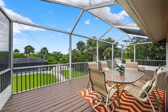 6120 Henderson Rd, Sanibel, FL 33957 - wooden deck with a lawn, a lanai, and outdoor dining area