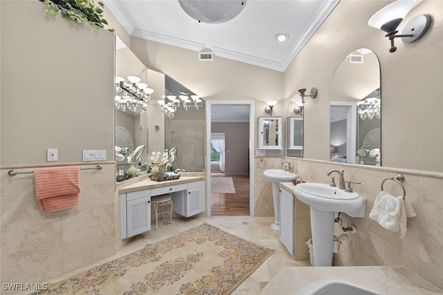 6120 Henderson Rd, Sanibel, FL 33957 - full bathroom with crown molding, tile walls, two sinks, and a wainscoted wall