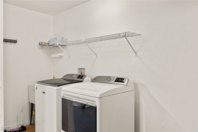 19897 Midway Blvd, Port Charlotte, FL 33948 - laundry area featuring washer and dryer and baseboards