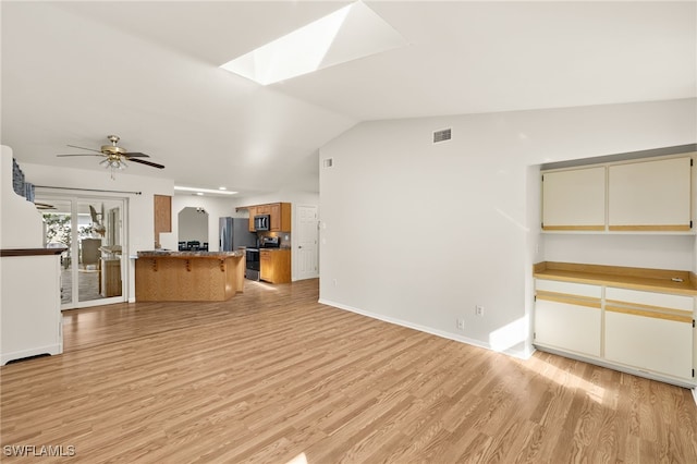 19897 Midway Blvd, Port Charlotte, FL 33948 - unfurnished living room with light wood-style flooring, a skylight, lofted ceiling, and a ceiling fan