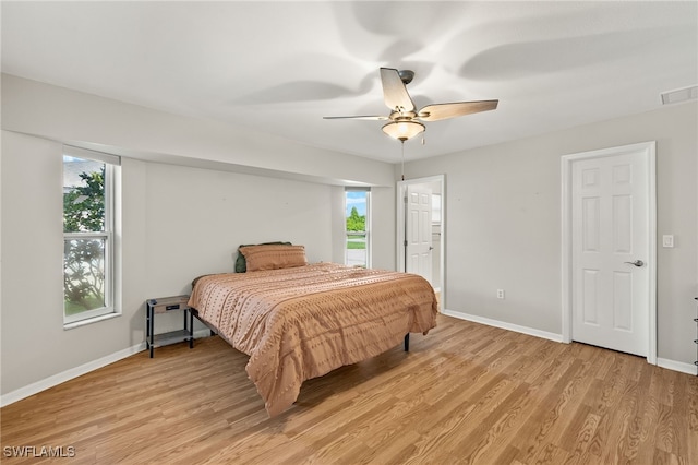 19897 Midway Blvd, Port Charlotte, FL 33948 - bedroom featuring multiple windows, light wood-type flooring, and a ceiling fan