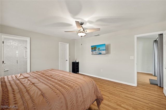 19897 Midway Blvd, Port Charlotte, FL 33948 - bedroom with light wood finished floors, ceiling fan, and ensuite bathroom
