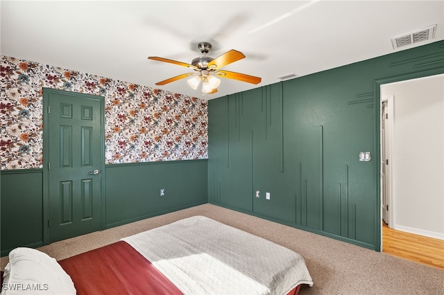 19897 Midway Blvd, Port Charlotte, FL 33948 - bedroom featuring a wainscoted wall, wallpapered walls, a ceiling fan, and carpet floors