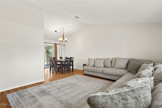 19897 Midway Blvd, Port Charlotte, FL 33948 - living area featuring lofted ceiling, a chandelier, and wood finished floors