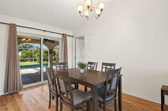 19897 Midway Blvd, Port Charlotte, FL 33948 - dining room with vaulted ceiling, a chandelier, light wood finished floors, and a ceiling fan