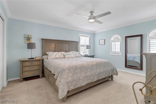5730 Lago Villaggio Way, Naples, FL 34104 - bedroom with light colored carpet, ornamental molding, a ceiling fan, and a closet
