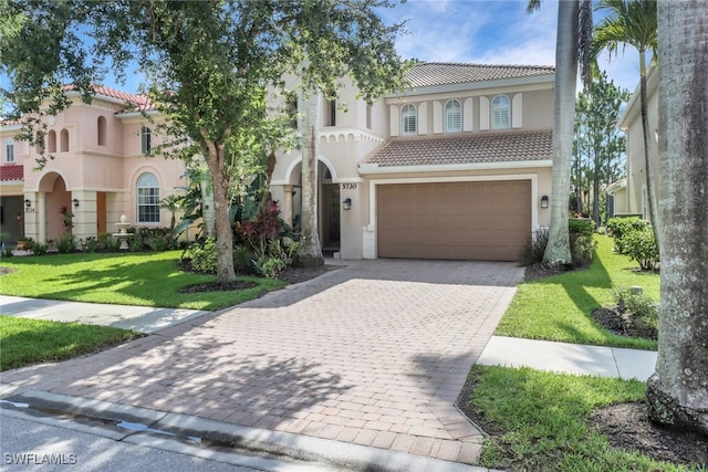 5730 Lago Villaggio Way, Naples, FL 34104 - mediterranean / spanish-style home featuring a tile roof, a garage, stucco siding, decorative driveway, and a front yard