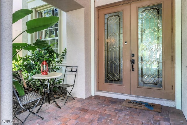 5730 Lago Villaggio Way, Naples, FL 34104 - view of exterior entry featuring french doors and stucco siding