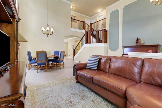 5730 Lago Villaggio Way, Naples, FL 34104 - tiled living area featuring arched walkways, stairway, a chandelier, a high ceiling, and ornamental molding