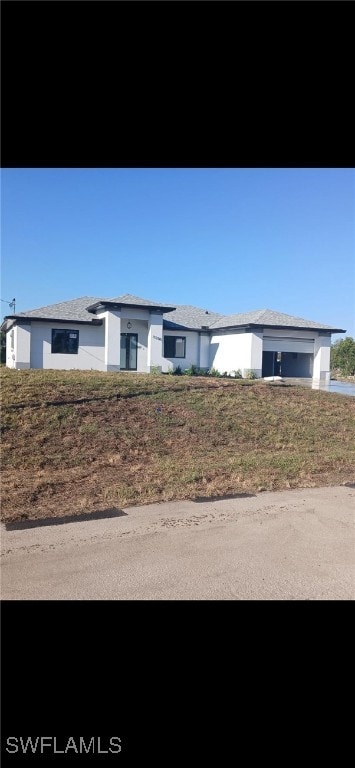 3206 28th St SW, Lehigh Acres, FL 33976 - view of front of property with a garage