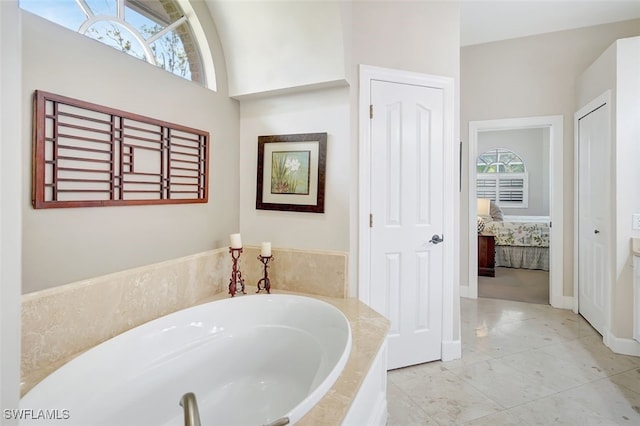 41 Timberland Cir S, Fort Myers, FL 33919 - ensuite bathroom featuring a garden tub and baseboards