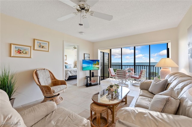 400 E Lenell Unit 110, Fort Myers Beach, FL 33931 - living area featuring ceiling fan, a textured ceiling, and light tile patterned floors