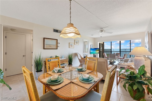 400 E Lenell Unit 110, Fort Myers Beach, FL 33931 - dining room featuring light tile patterned floors, a textured ceiling, and a ceiling fan