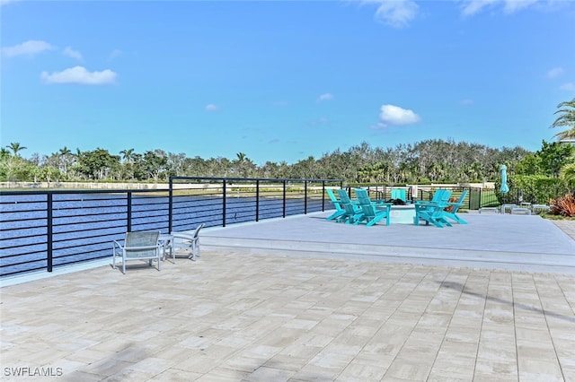 4720 Arboretum Cir Unit 102, Naples, FL 34112 - view of patio / terrace with view of wooded area and a fire pit