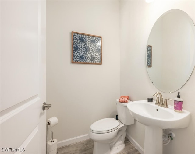4720 Arboretum Cir Unit 102, Naples, FL 34112 - half bathroom featuring wood finished floors and toilet