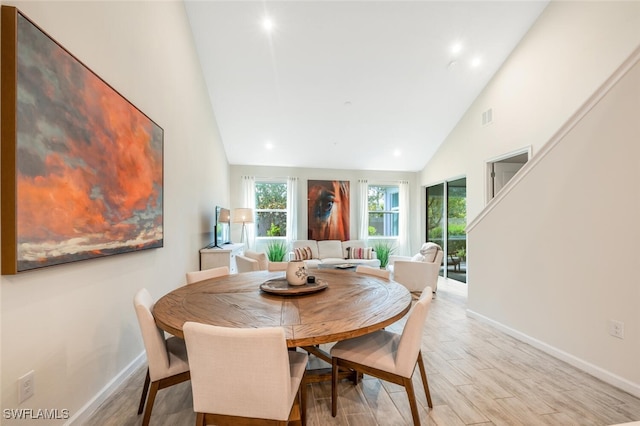 4720 Arboretum Cir Unit 102, Naples, FL 34112 - dining space featuring plenty of natural light, high vaulted ceiling, and light wood finished floors