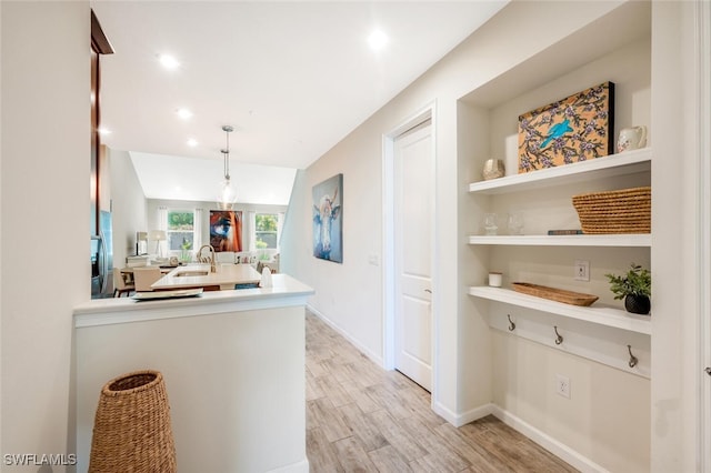 4720 Arboretum Cir Unit 102, Naples, FL 34112 - kitchen with light countertops, light wood finished floors, a peninsula, pendant lighting, and recessed lighting
