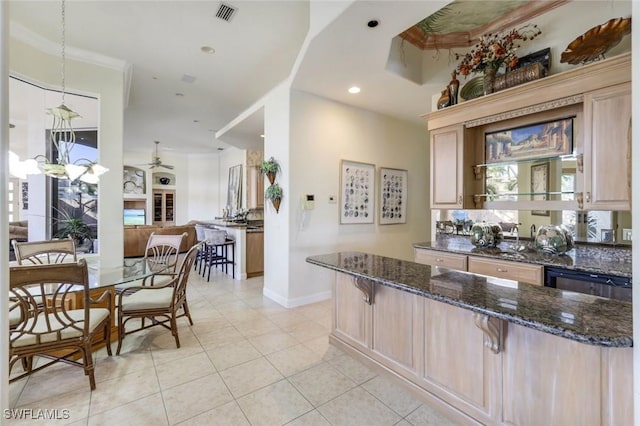 14581 Headwater Bay Ln, Fort Myers, FL 33908 - kitchen with a ceiling fan, light tile patterned floors, a kitchen bar, dark stone counters, and crown molding