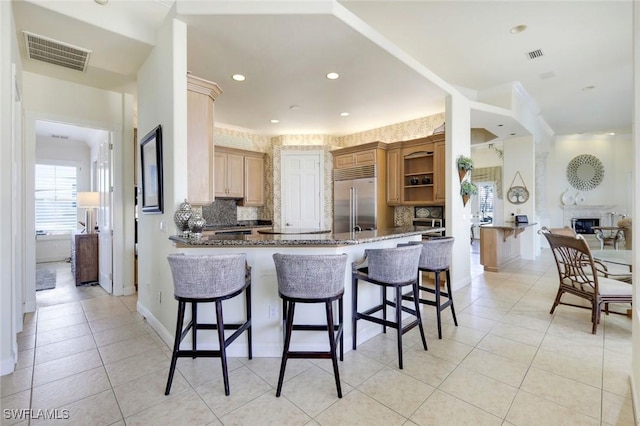 14581 Headwater Bay Ln, Fort Myers, FL 33908 - kitchen with built in refrigerator, light tile patterned flooring, a peninsula, decorative backsplash, and recessed lighting