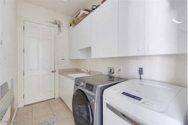 14581 Headwater Bay Ln, Fort Myers, FL 33908 - laundry area with cabinet space, separate washer and dryer, and light tile patterned floors