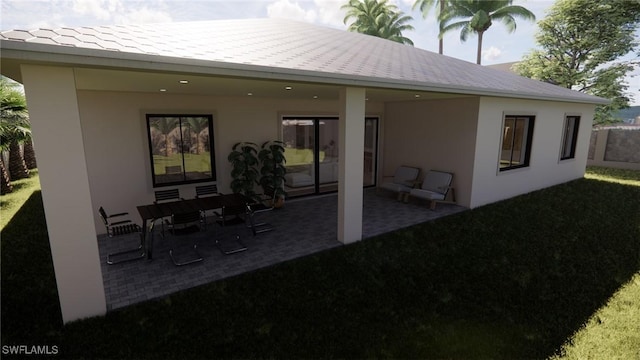 1021 Gaucho Ter, North Port, FL 34286 - rear view of house with a patio area, stucco siding, and a yard