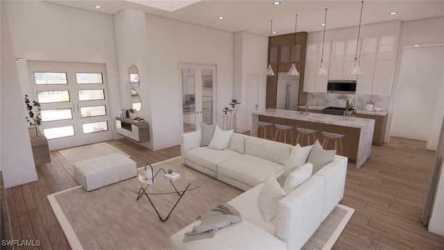 1021 Gaucho Ter, North Port, FL 34286 - living room featuring light wood-style floors, a high ceiling, and recessed lighting