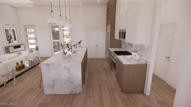 1021 Gaucho Ter, North Port, FL 34286 - kitchen featuring stainless steel microwave, a high ceiling, light wood-type flooring, decorative light fixtures, and black stovetop