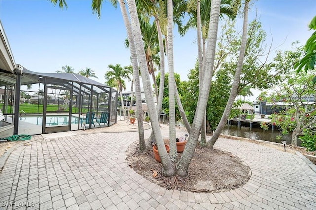 1138 Lucerne Ave, Cape Coral, FL 33904 - view of property's community featuring a pool, a patio area, and a water view