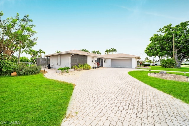 1138 Lucerne Ave, Cape Coral, FL 33904 - view of front of home with decorative driveway, a garage, stucco siding, and a front lawn