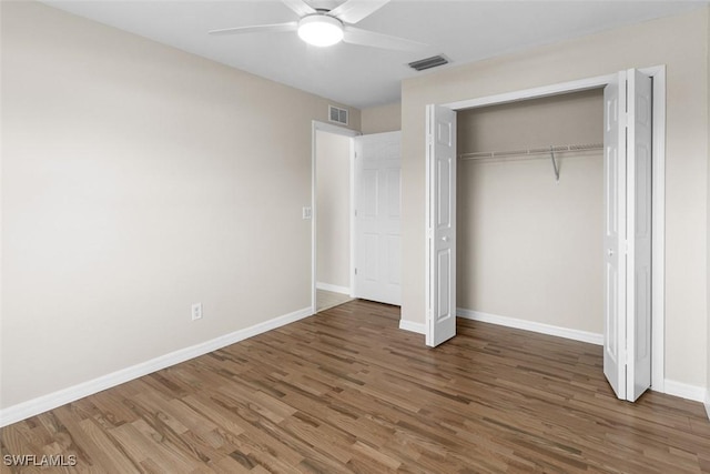 2811 44th St W, Lehigh Acres, FL 33971 - unfurnished bedroom with wood finished floors, a closet, and a ceiling fan