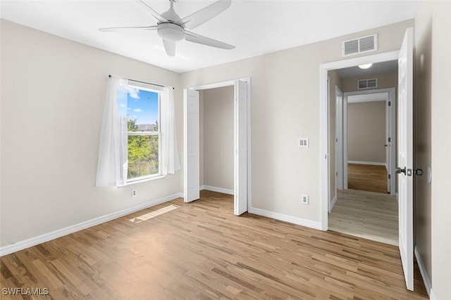 2811 44th St W, Lehigh Acres, FL 33971 - unfurnished bedroom featuring light wood-style flooring, a ceiling fan, and a closet