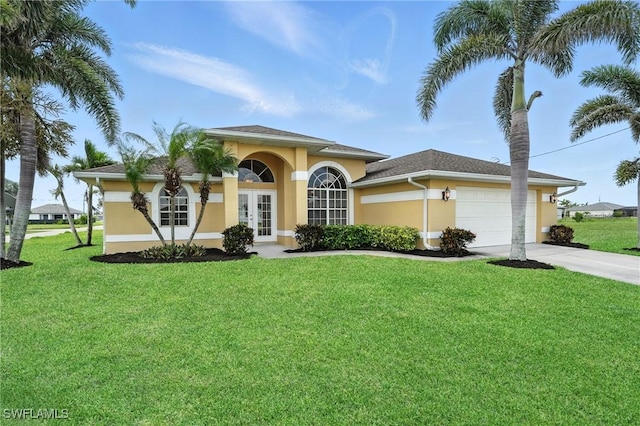 4322 NW 32nd Ter, Cape Coral, FL 33993 - mediterranean / spanish house featuring french doors, stucco siding, driveway, and a front yard