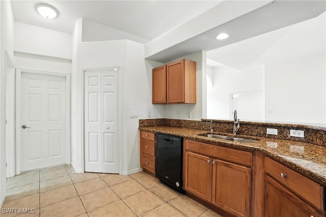 4322 NW 32nd Ter, Cape Coral, FL 33993 - kitchen with black dishwasher, dark stone counters, light tile patterned floors, and brown cabinets