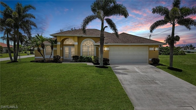 4322 NW 32nd Ter, Cape Coral, FL 33993 - view of front of home featuring french doors, stucco siding, a garage, a front yard, and concrete driveway