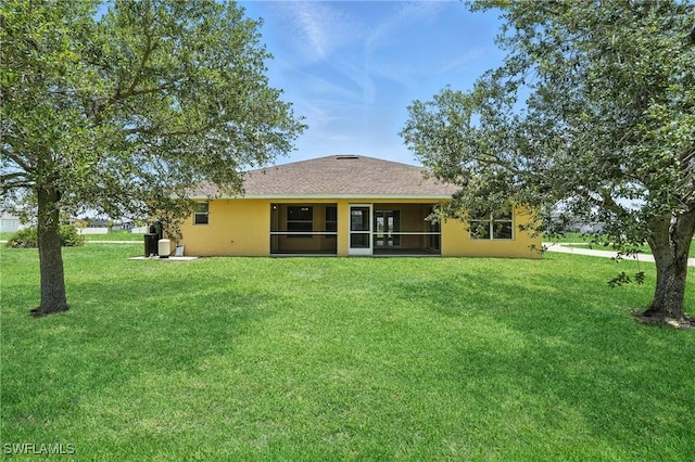 4322 NW 32nd Ter, Cape Coral, FL 33993 - rear view of property with a lawn, a sunroom, and stucco siding