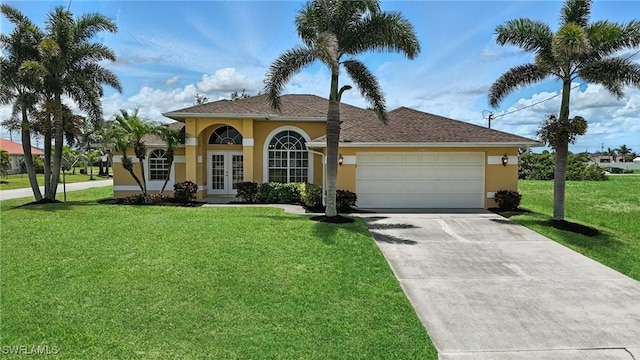 4322 NW 32nd Ter, Cape Coral, FL 33993 - view of front of house with french doors, stucco siding, an attached garage, and a front lawn