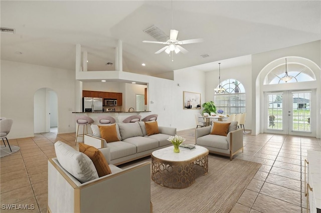 4322 NW 32nd Ter, Cape Coral, FL 33993 - living area featuring arched walkways, high vaulted ceiling, french doors, a ceiling fan, and light tile patterned flooring